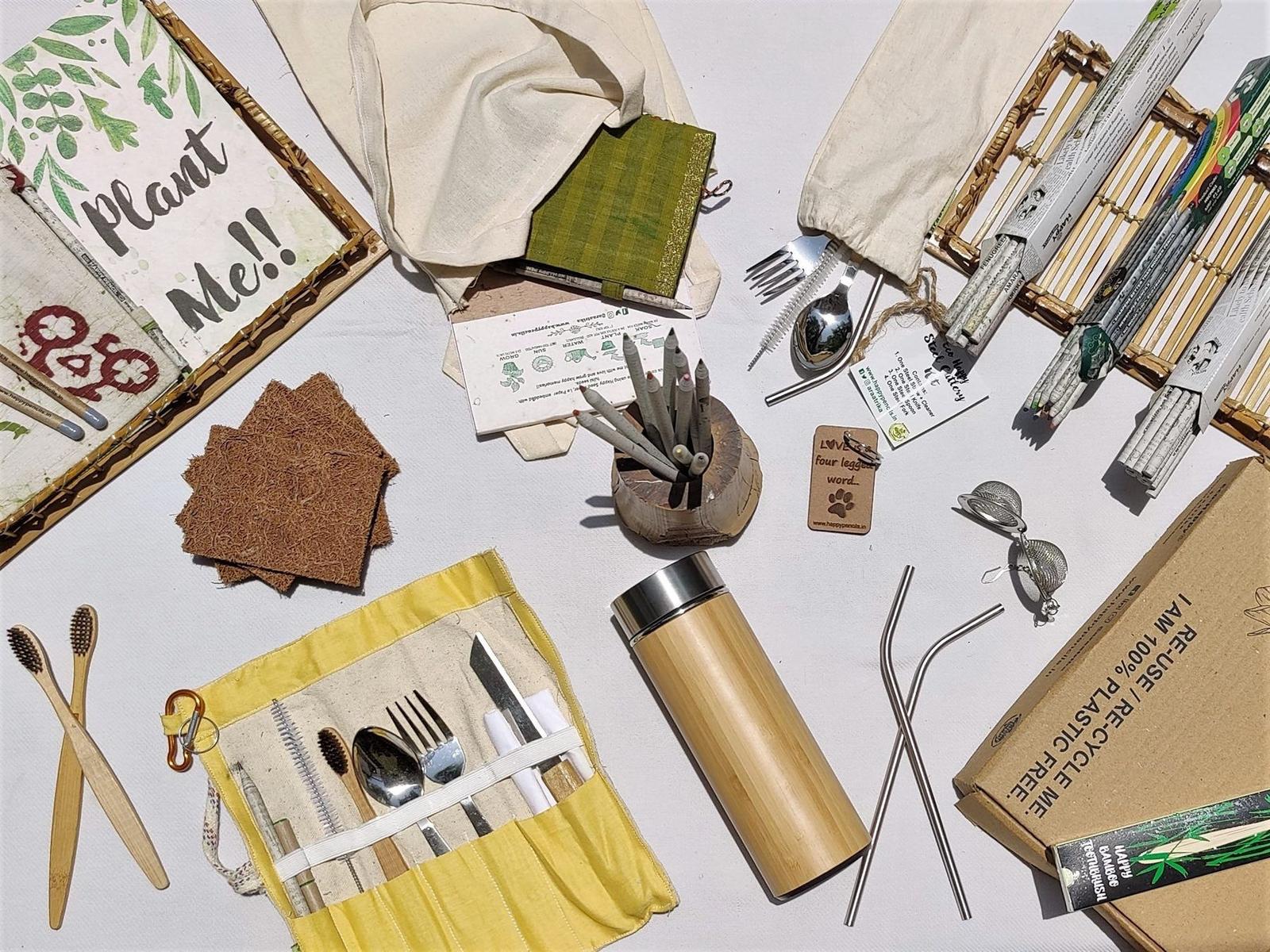 A flat-lay of Eco Happy's seed pencils, upcycled diaries and plantable kits on a cream cloth