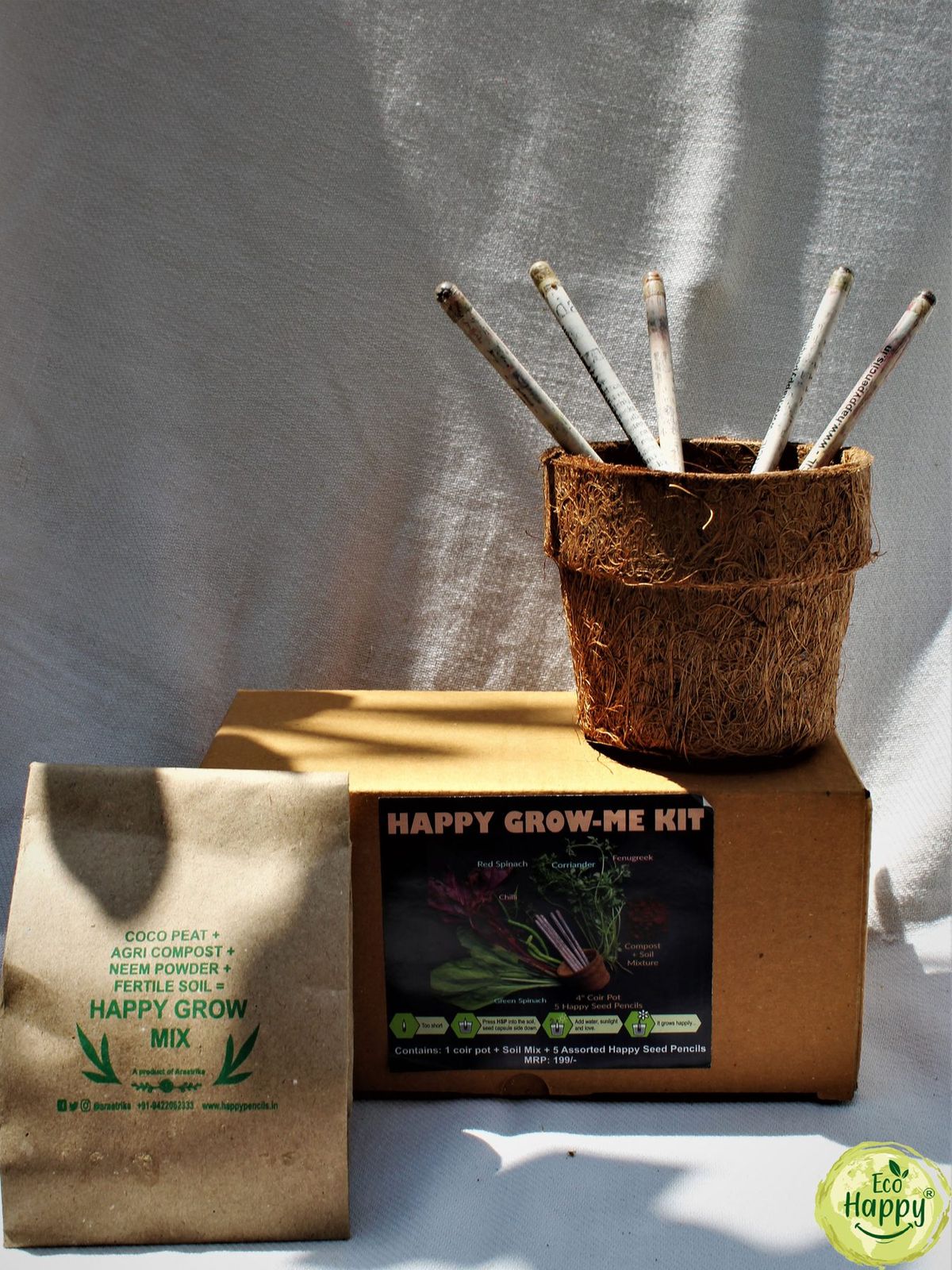 The Eco Happy Grow Me Kit box opened to show the soil mix, seed packet and planting pot inside