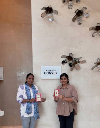 Two Eco Happy team members handing over gift boxes at a Marriott Bonvoy corporate gifting delivery